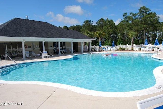 pool featuring fence and a patio