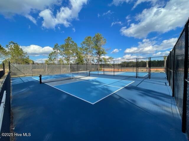 view of tennis court with fence