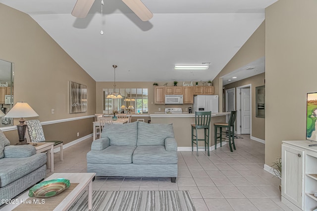 living area featuring high vaulted ceiling, light tile patterned floors, baseboards, and a ceiling fan