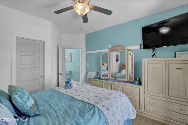 bedroom with light wood-style floors and ceiling fan