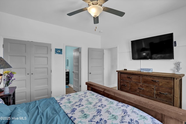 bedroom featuring a closet, connected bathroom, baseboards, and ceiling fan