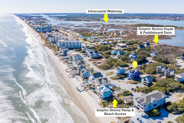 drone / aerial view with a beach view and a water view