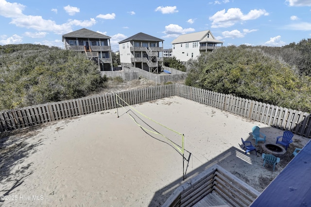 view of yard with a fenced backyard and volleyball court