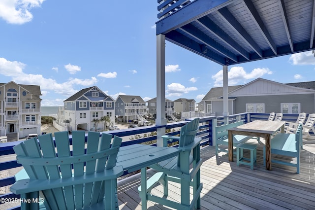 deck featuring a residential view and outdoor dining area