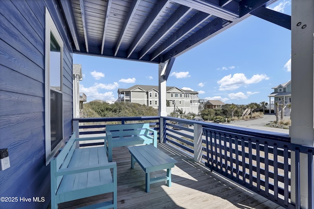 view of wooden balcony featuring a wooden deck and a residential view