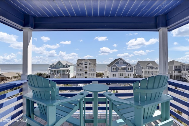 balcony with a residential view and a water view