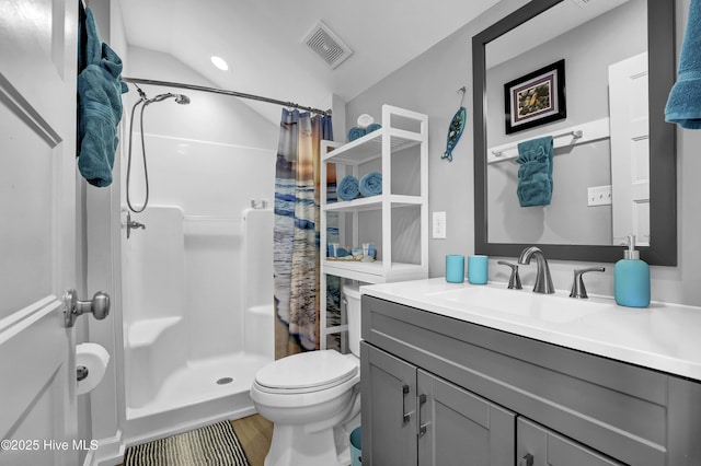 bathroom featuring visible vents, a shower stall, toilet, vaulted ceiling, and vanity