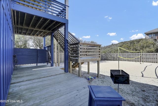 wooden deck featuring stairway and a fenced backyard