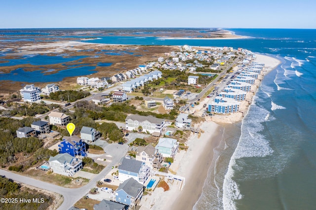 drone / aerial view featuring a beach view and a water view