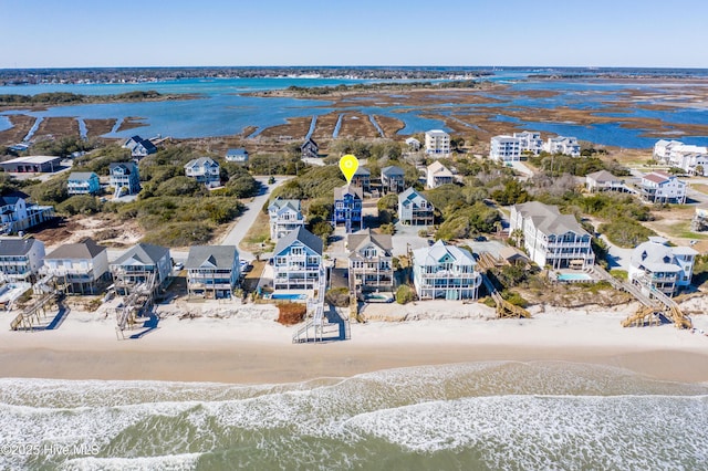 bird's eye view with a residential view, a water view, and a view of the beach