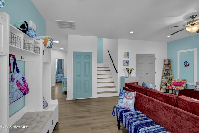 living room with visible vents, stairway, recessed lighting, light wood-style flooring, and a ceiling fan