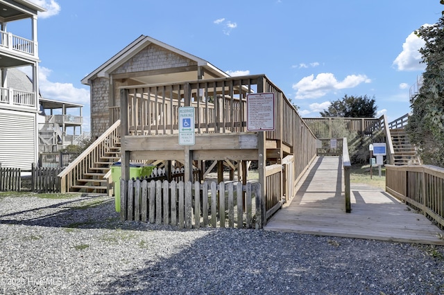 back of property featuring a wooden deck and stairs