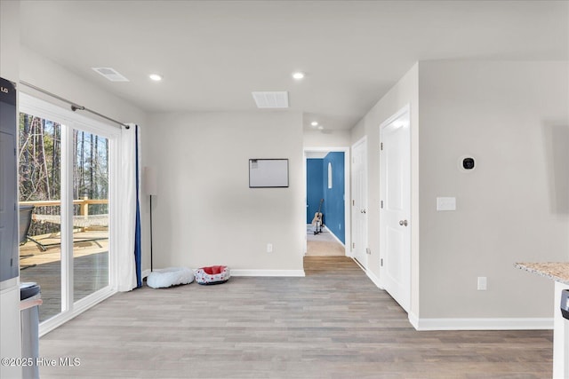 empty room featuring recessed lighting, visible vents, baseboards, and wood finished floors