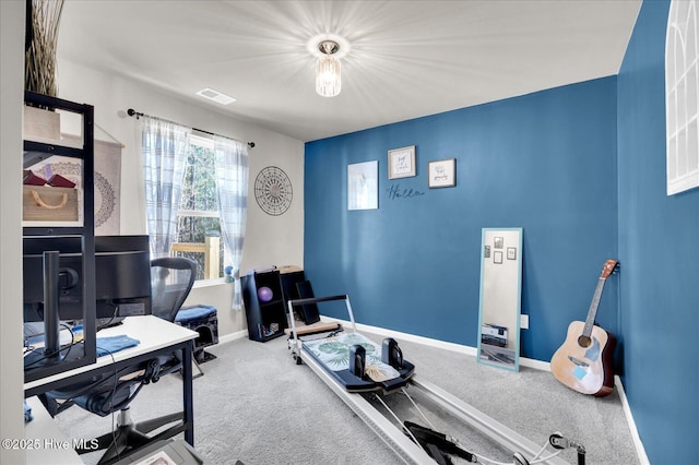 carpeted home office with visible vents and baseboards