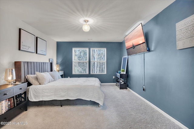 bedroom featuring carpet flooring and baseboards