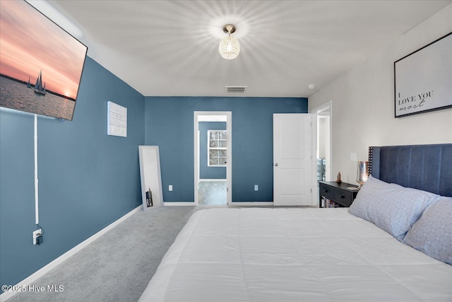 carpeted bedroom with visible vents and baseboards