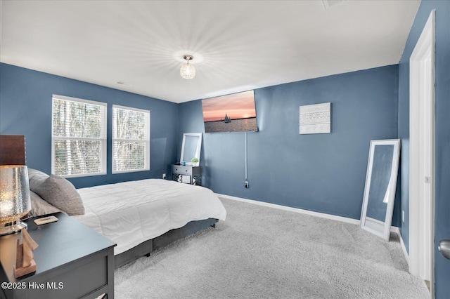 carpeted bedroom with visible vents and baseboards