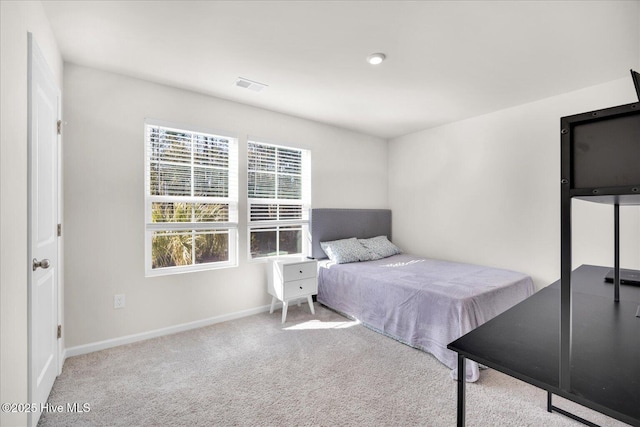 carpeted bedroom with visible vents and baseboards