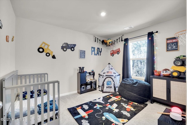 carpeted bedroom with visible vents and baseboards