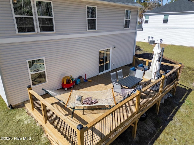 back of house with a deck and central AC unit