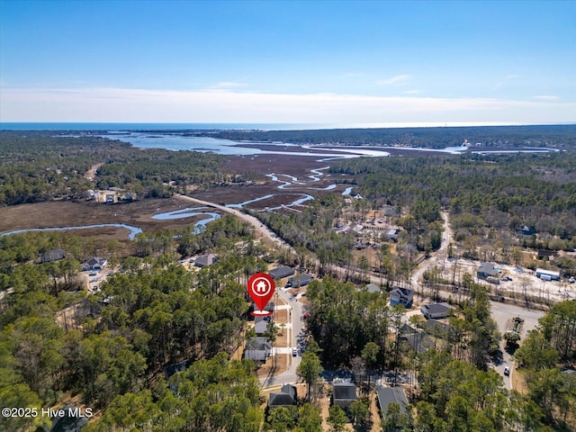 aerial view with a water view and a forest view