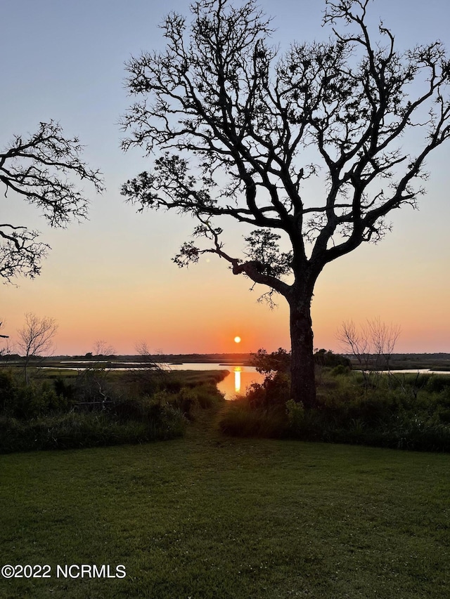 yard at dusk with a water view