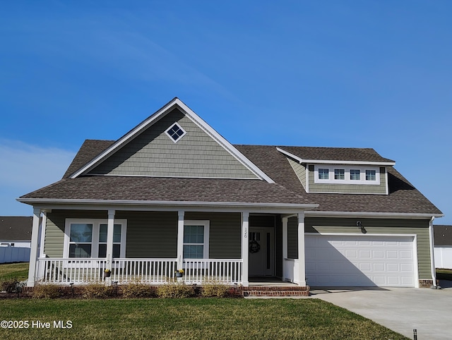 view of front of home featuring driveway, roof with shingles, an attached garage, covered porch, and a front lawn