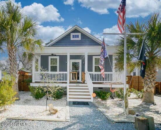 226 NE 76th St, Oak Island, NC 28465 - view of front of home featuring covered porch, crawl space, and stairs