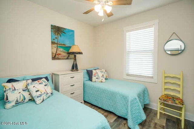 226 NE 76th St, Oak Island, NC 28465 - bedroom with wood finished floors, baseboards, and a ceiling fan