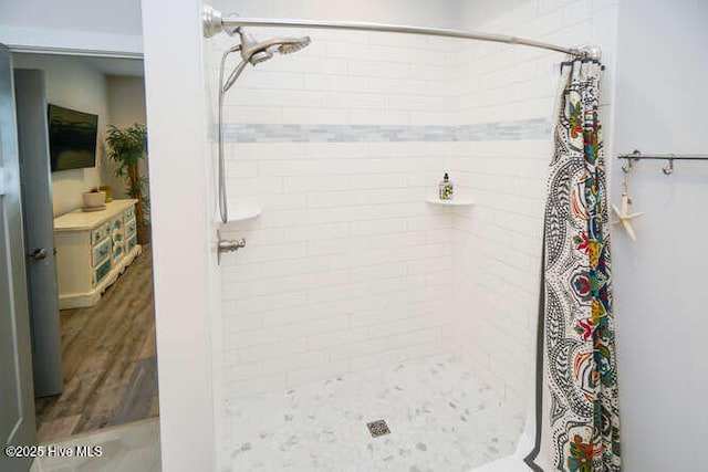 226 NE 76th St, Oak Island, NC 28465 - full bathroom featuring a stall shower and wood finished floors