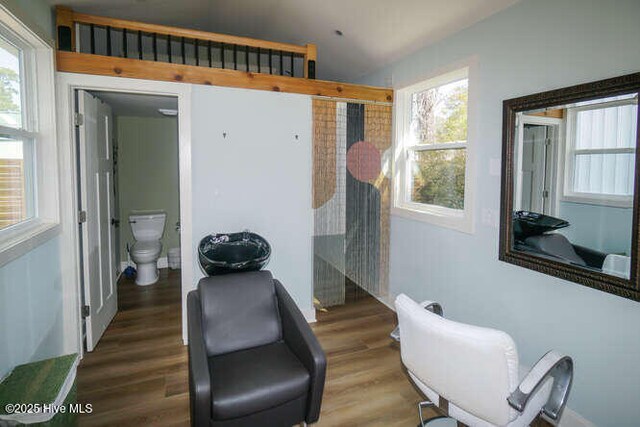 226 NE 76th St, Oak Island, NC 28465 - living area featuring plenty of natural light and wood finished floors
