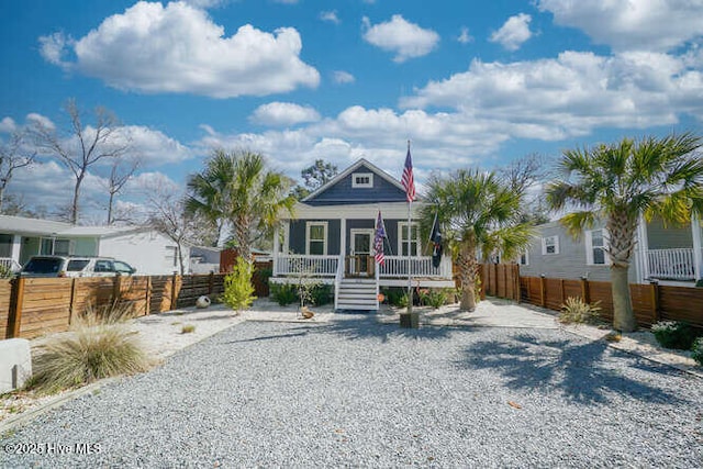 226 NE 76th St, Oak Island, NC 28465 - view of front facade featuring covered porch