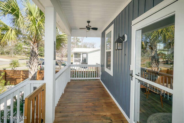 226 NE 76th St, Oak Island, NC 28465 - wooden porch featuring ceiling fan