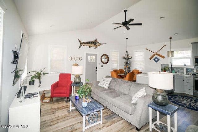 226 NE 76th St, Oak Island, NC 28465 - living room featuring light wood-type flooring, lofted ceiling, and a ceiling fan