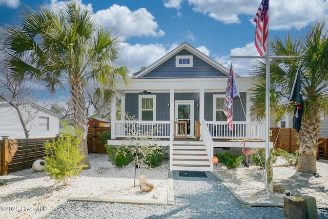 226 NE 76th St, Oak Island, NC 28465 - view of front facade with a porch and board and batten siding