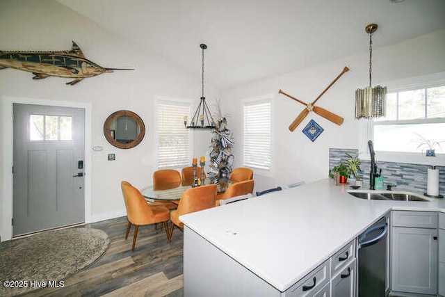 226 NE 76th St, Oak Island, NC 28465 - kitchen with a sink, dark wood finished floors, dishwashing machine, pendant lighting, and light countertops