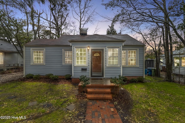 view of front of house featuring a chimney