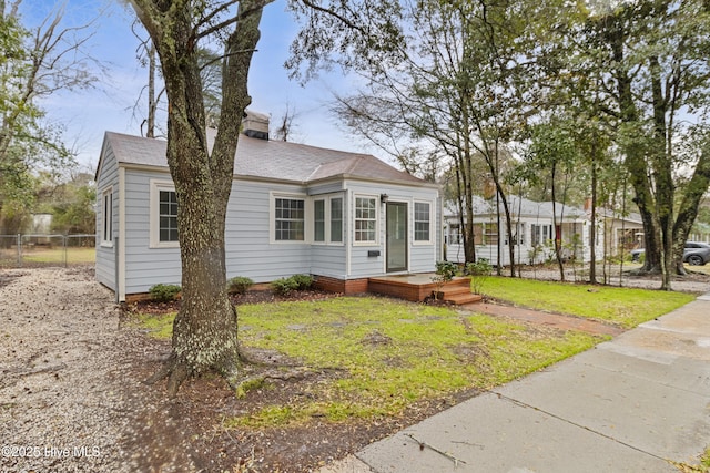 view of front of property with fence and a front lawn