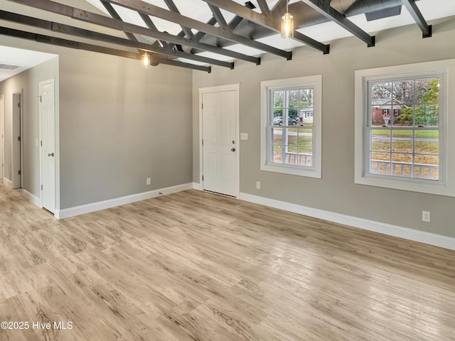 unfurnished living room with light wood-style flooring, vaulted ceiling with beams, and baseboards