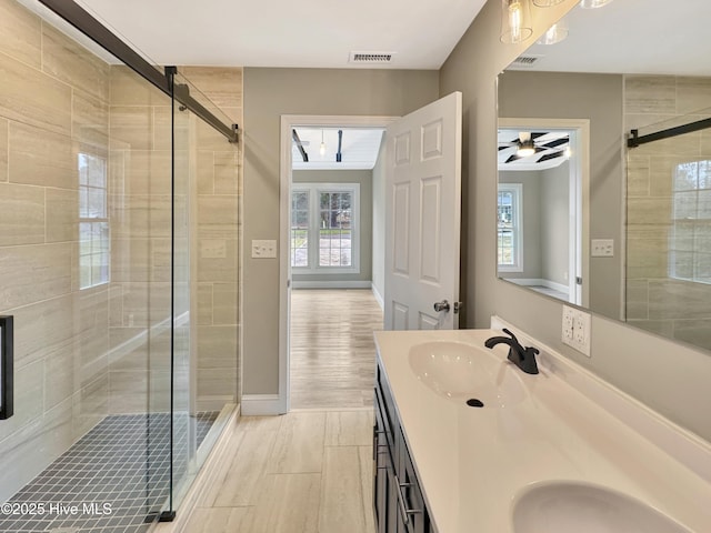 bathroom featuring a sink, visible vents, and a shower stall