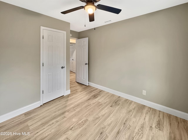 unfurnished bedroom featuring visible vents, baseboards, light wood-style flooring, and a ceiling fan