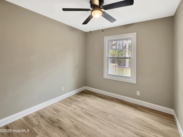 spare room with light wood-style flooring, baseboards, and ceiling fan