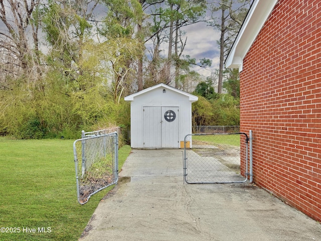 view of shed featuring fence and a gate