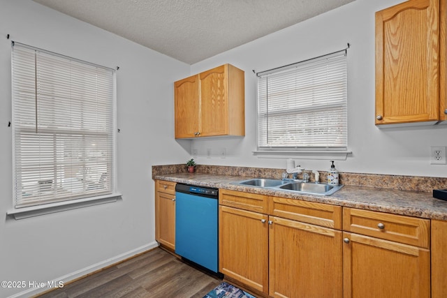 kitchen featuring a textured ceiling, dishwashing machine, dark wood-style flooring, a sink, and baseboards