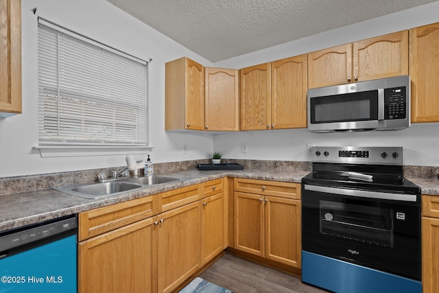 kitchen with electric stove, stainless steel microwave, a sink, a textured ceiling, and dishwashing machine