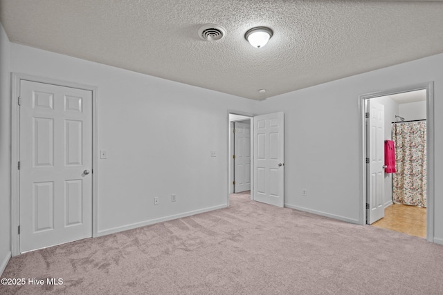 unfurnished bedroom with carpet, visible vents, and baseboards