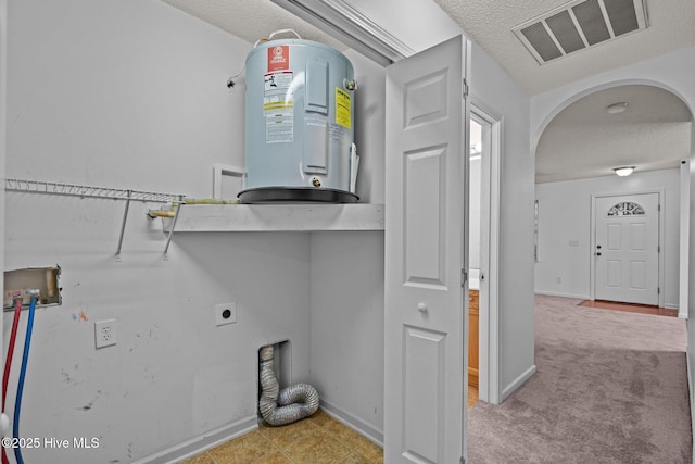 laundry area with laundry area, visible vents, arched walkways, hookup for a washing machine, and water heater