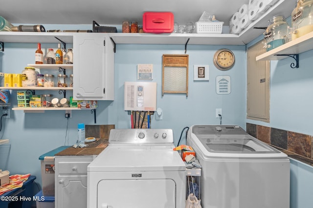 laundry room with electric panel, cabinet space, and independent washer and dryer