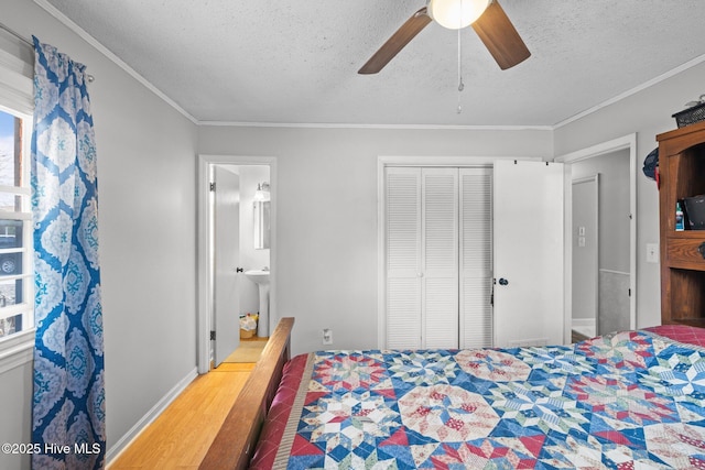 bedroom with ornamental molding, a closet, a textured ceiling, and wood finished floors