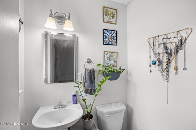 bathroom with toilet and a sink